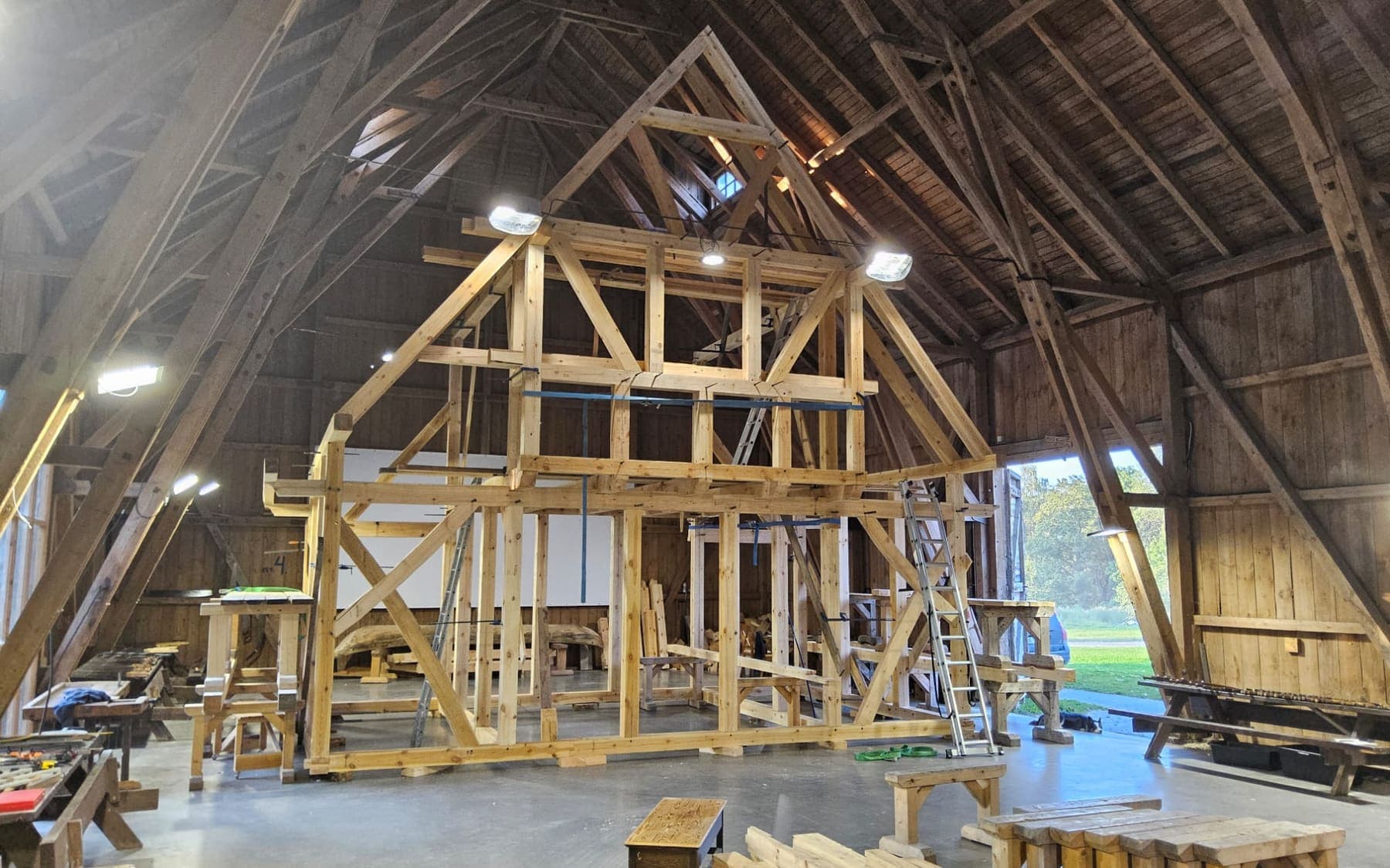 Two storey timber frame test fitted inside a large workshop barn